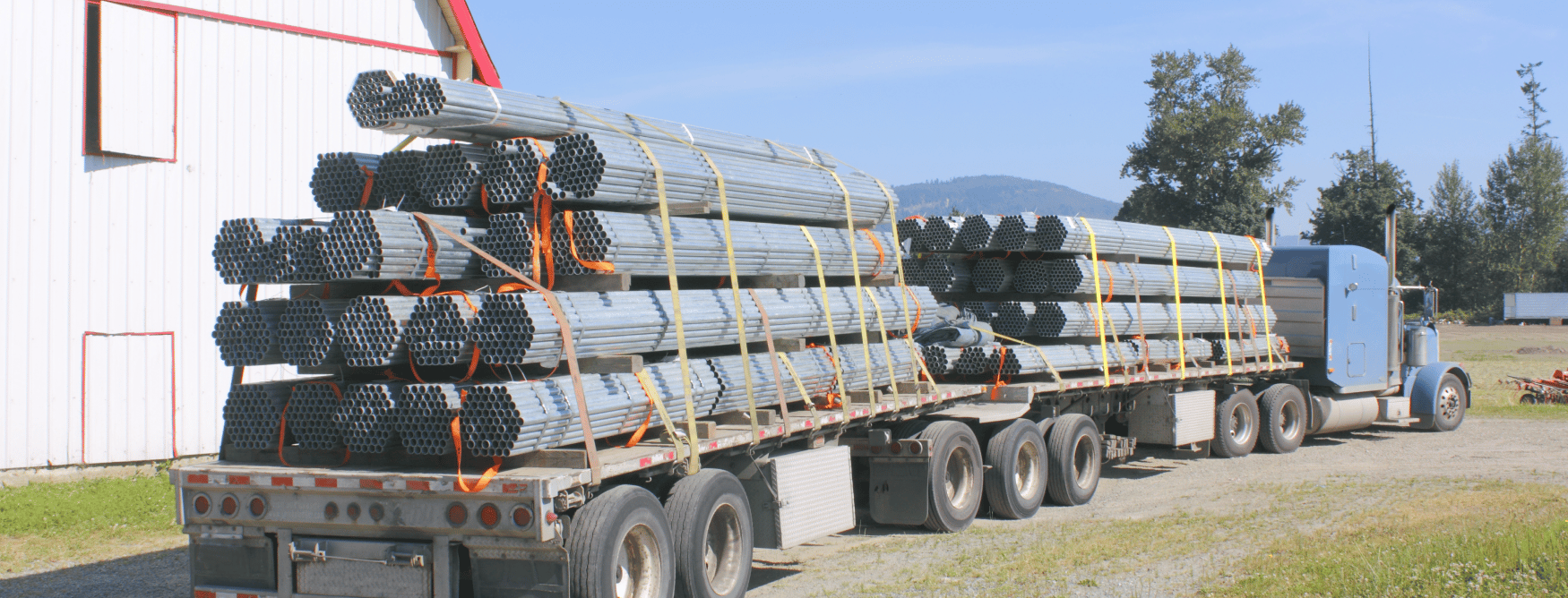 semi truck delivering pipes