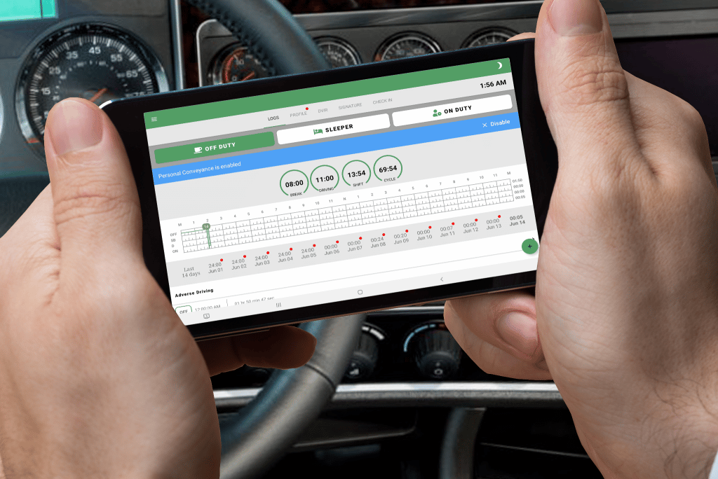 from the POV of the drivers seat, two hands hold a phone displaying the GPSTab app.