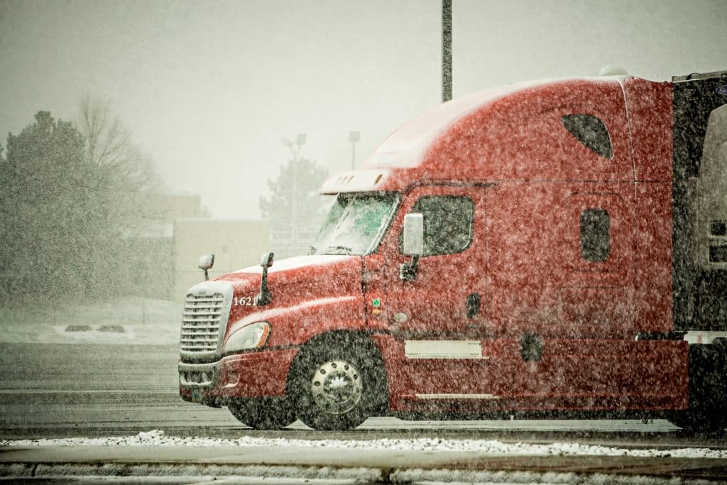 truck driving in snowy conditions