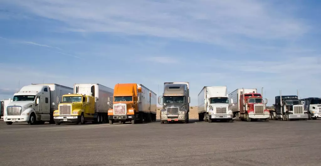 A group of large trucks in a row