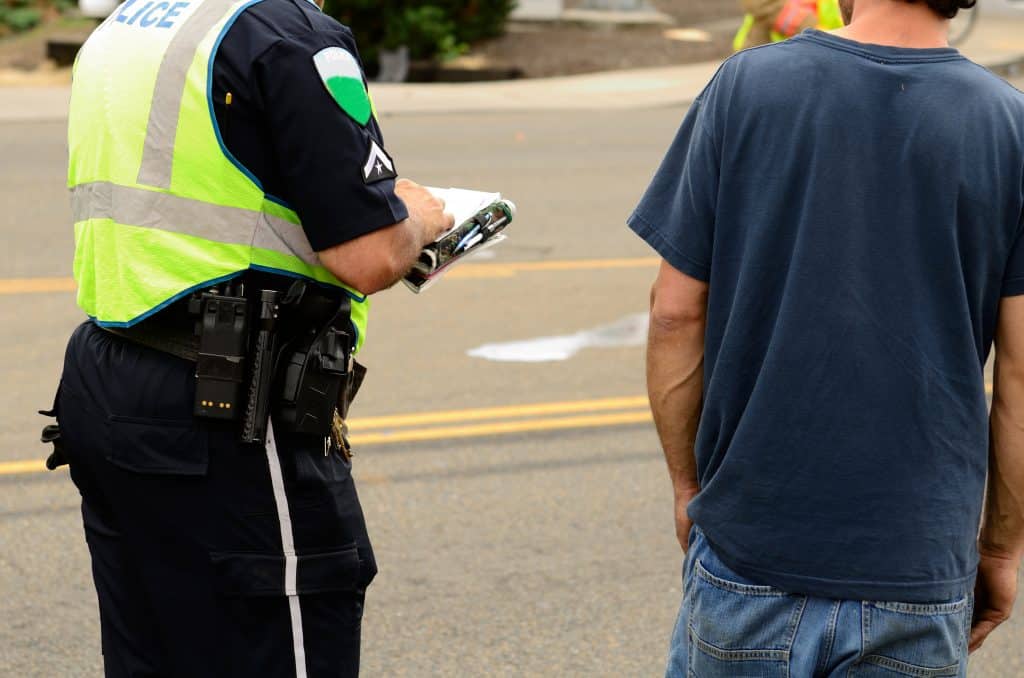 Police writing a citation at a four vehicle accident involving two large trucks resulted in a single injury and a diesel fuel spill. July 17, 2012 in Roseburg Oregon