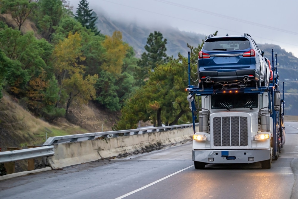 A semitruck driving down a road. 