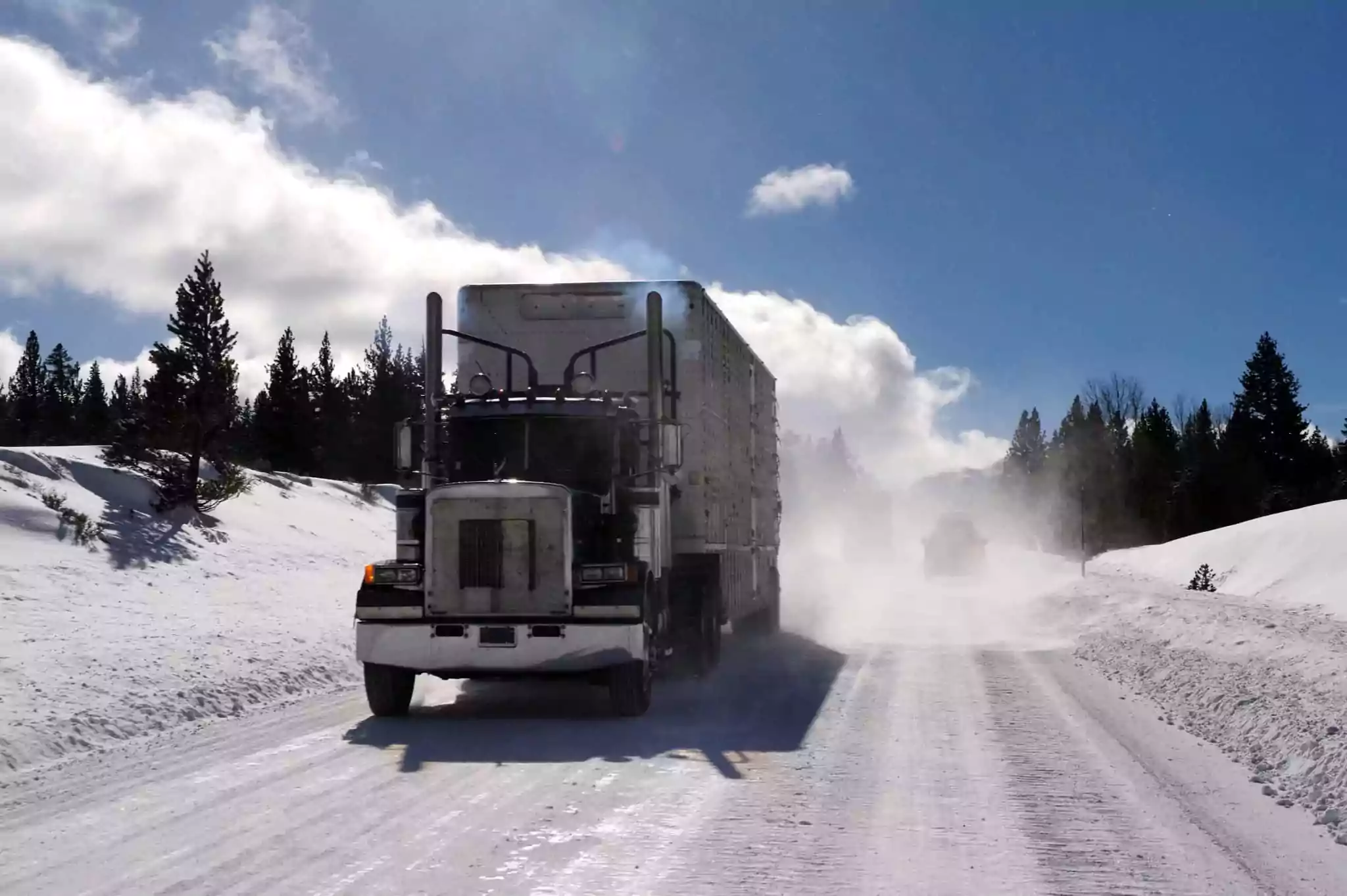 Truck driving on the snowy road